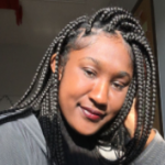 Headshot of Anaiya Martin inside in the sunlight with her hand by the side of her head